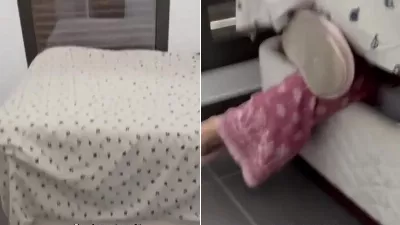 Elle cherchait quelque chose dans le meuble de son lit et s'est retrouvée coincée sous le matelas.