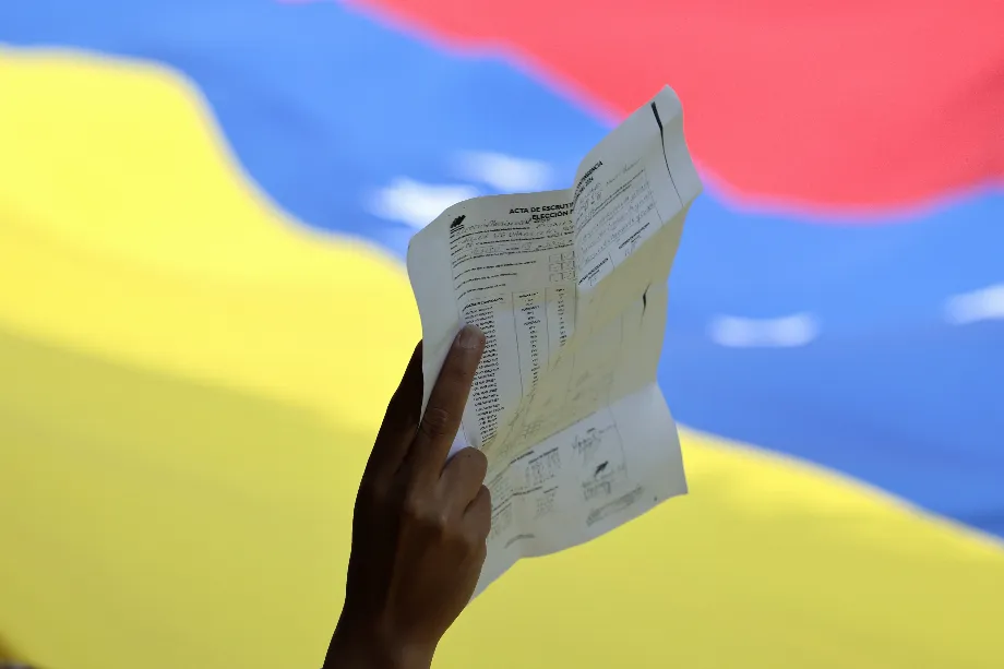 Une personne tient une copie d'un acte de vote lors d'une manifestation en rejet des résultats du Conseil National Électoral (CNE) - crédit José Méndez/EFE
